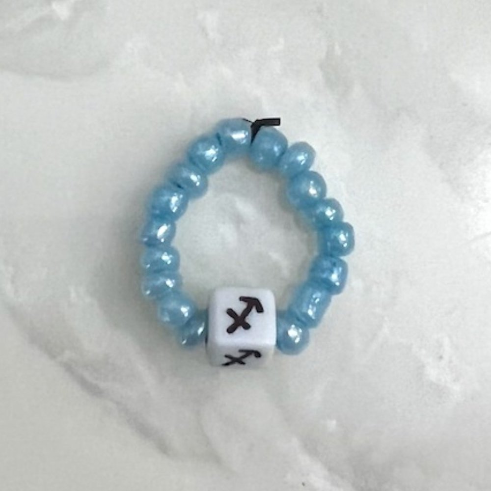 "SAGITTARIUS" HOROSCOPE BEADED RING, ONE SIZE, LIGHT BLUE BEADS